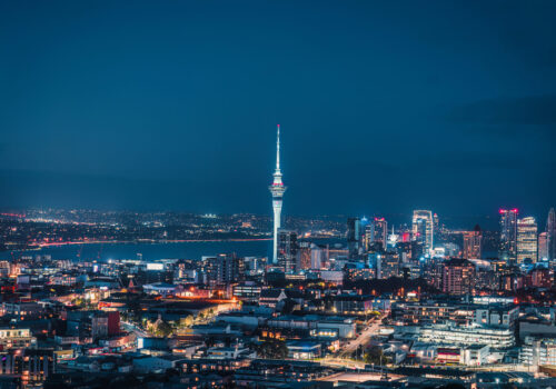 Cityscape of iconic sky tower with blue sky and business building during the dusk in central of Auckland at New Zealand