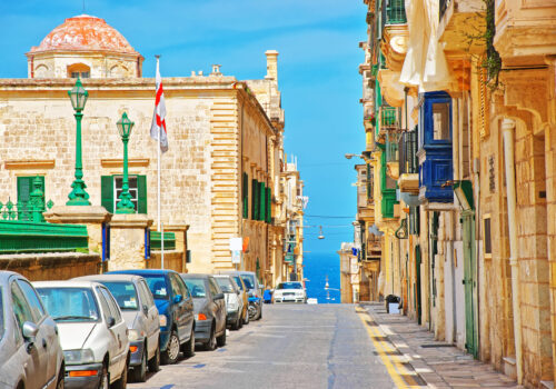 Valletta street view with dome of ancient church, Malta